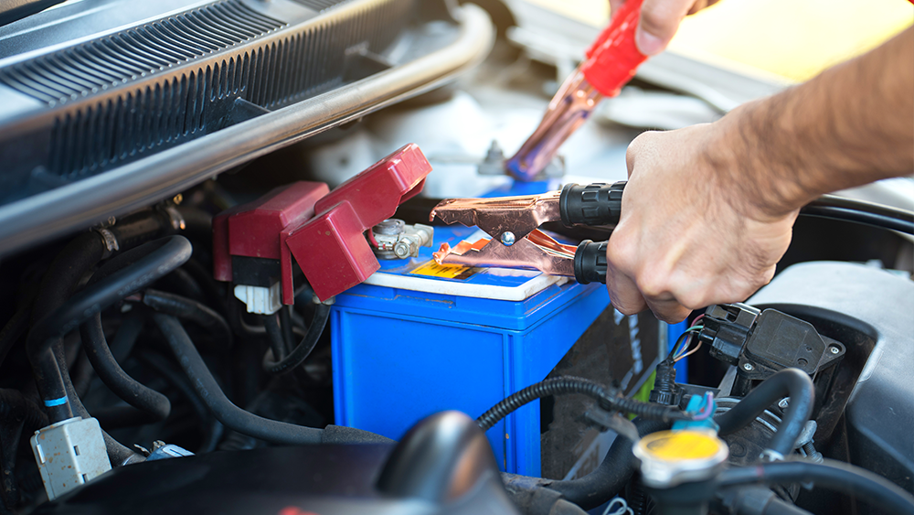 Technician performing alternator repair during electrical system diagnostic