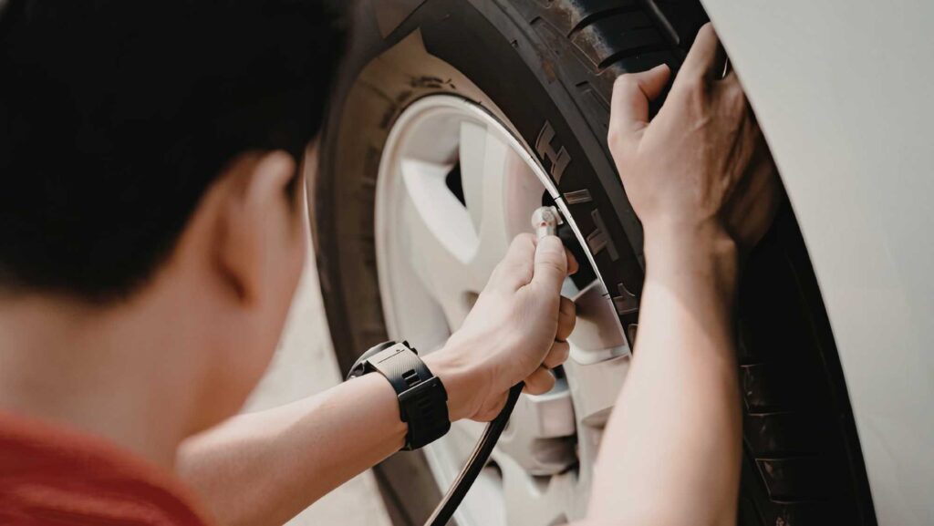 Technician checking recommended tire pressure during a safety inspection at Heart Certified Auto Care
