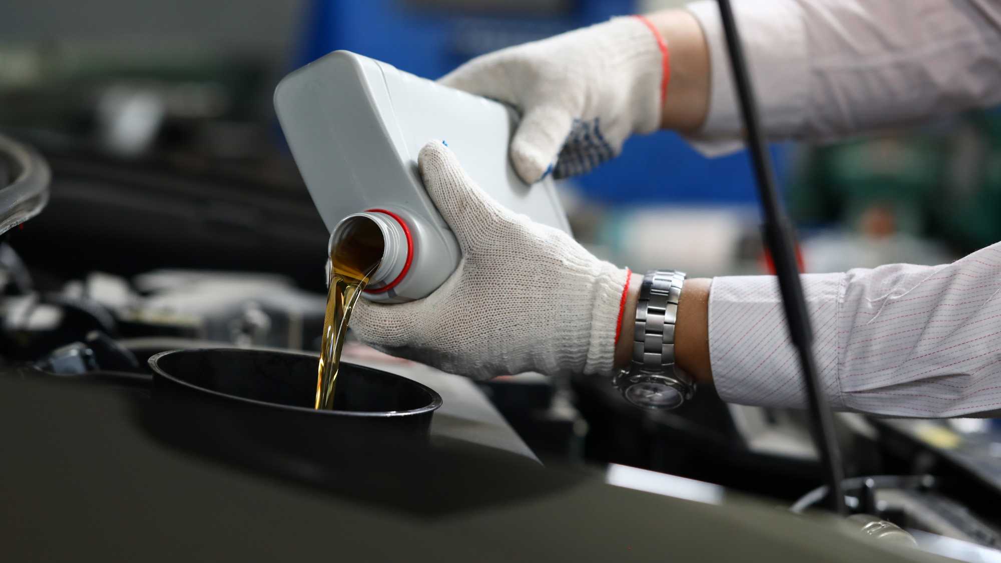 Technician performing an oil change at HEART Certified Auto Care