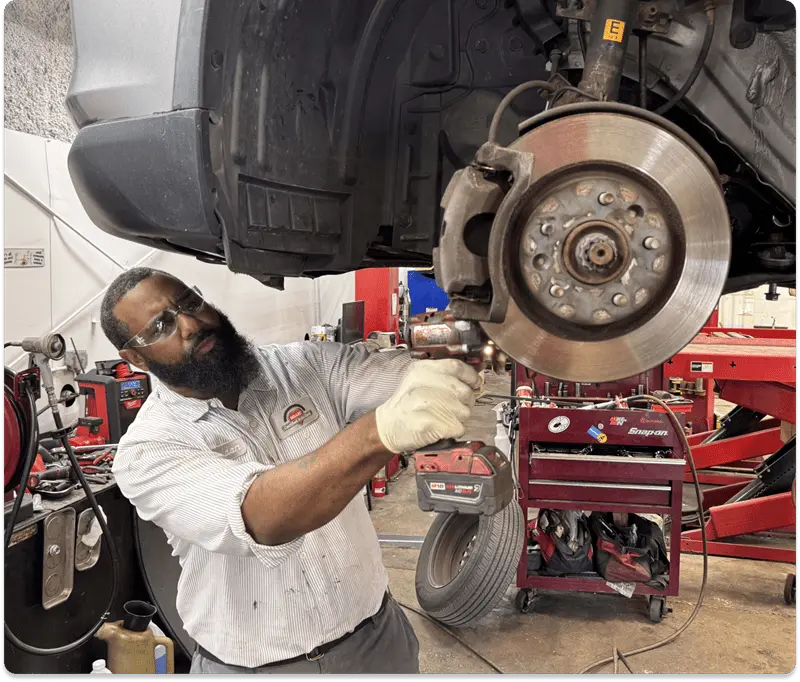 Technician checking brake calipers