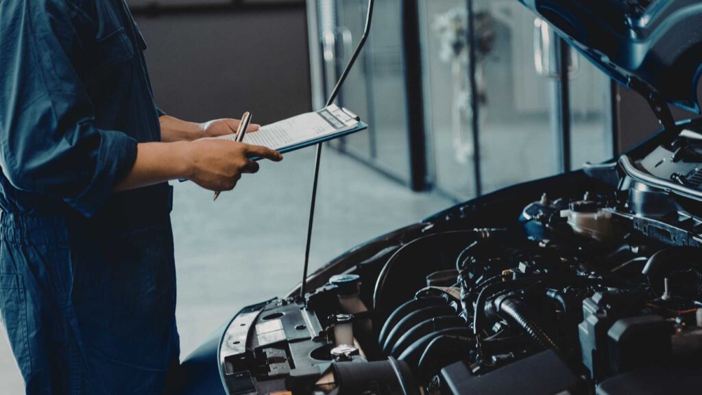 Technician performing a 33-point digital vehicle inspection at HEART Certified Auto Care
