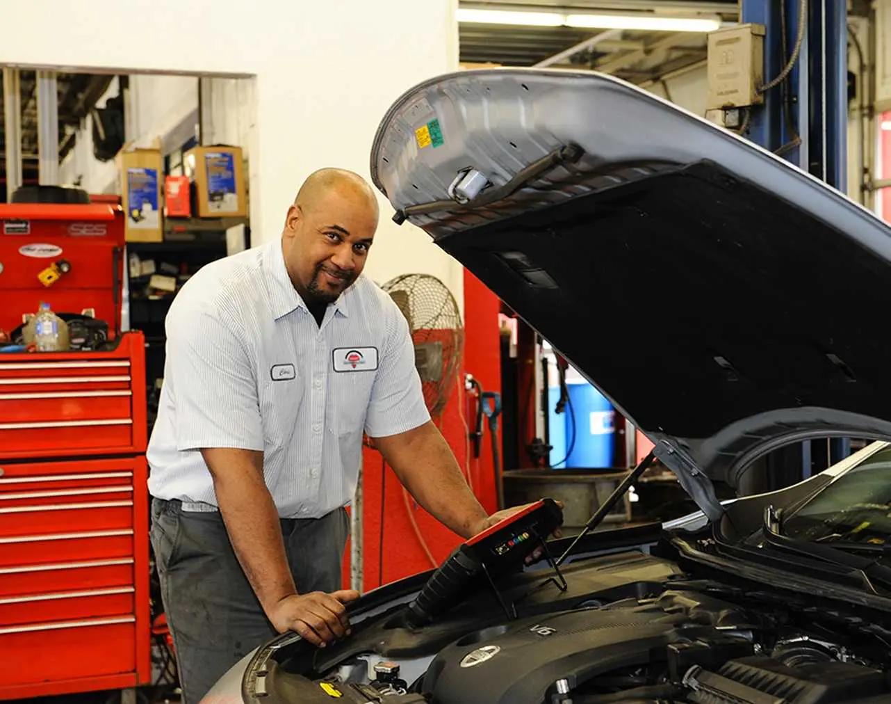 Technician checking car electrical issues
