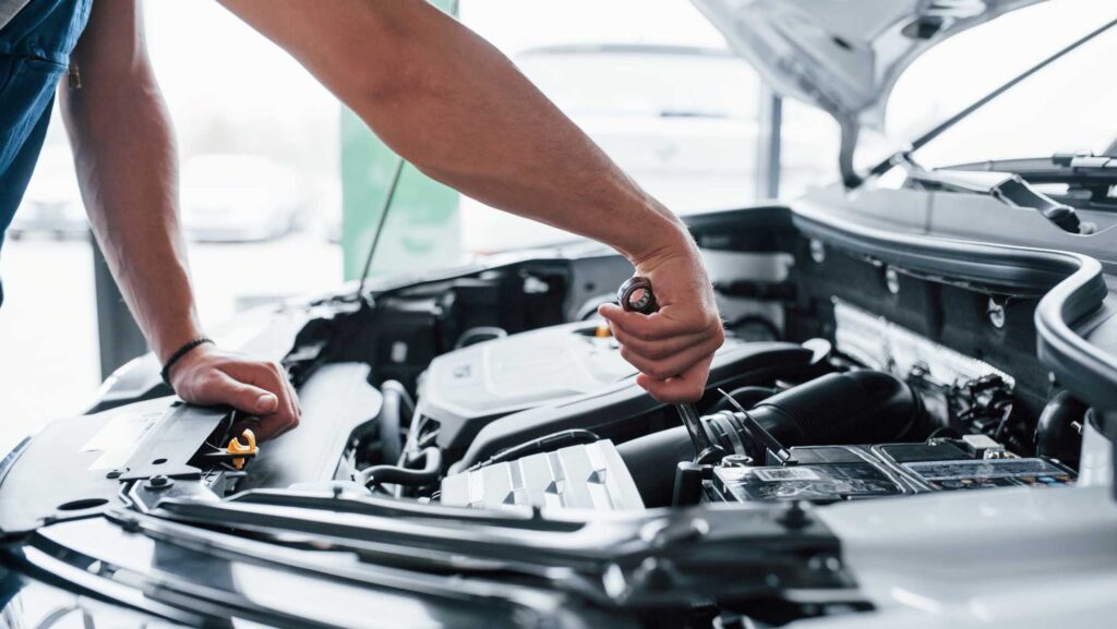 IL technician inspecting vehicle in an auto repair service near Mundelein.