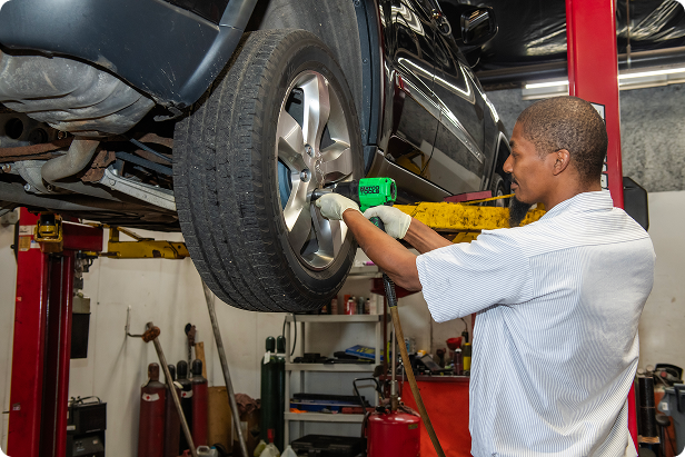 Mechanic inspecting and installing a tire