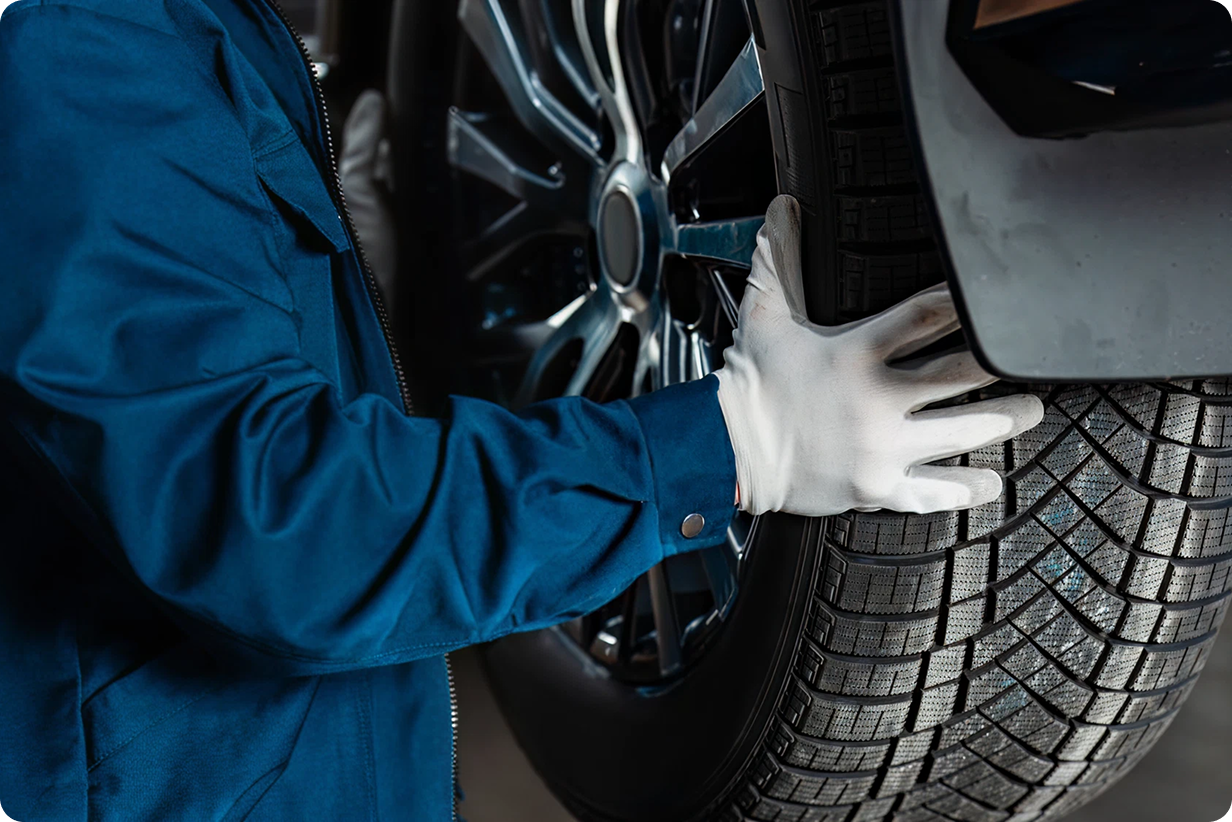Mechanic inspecting and installing a tire
