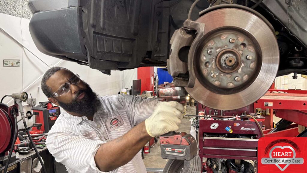 Mechanic inspecting squeaky brakes in Evanston IL