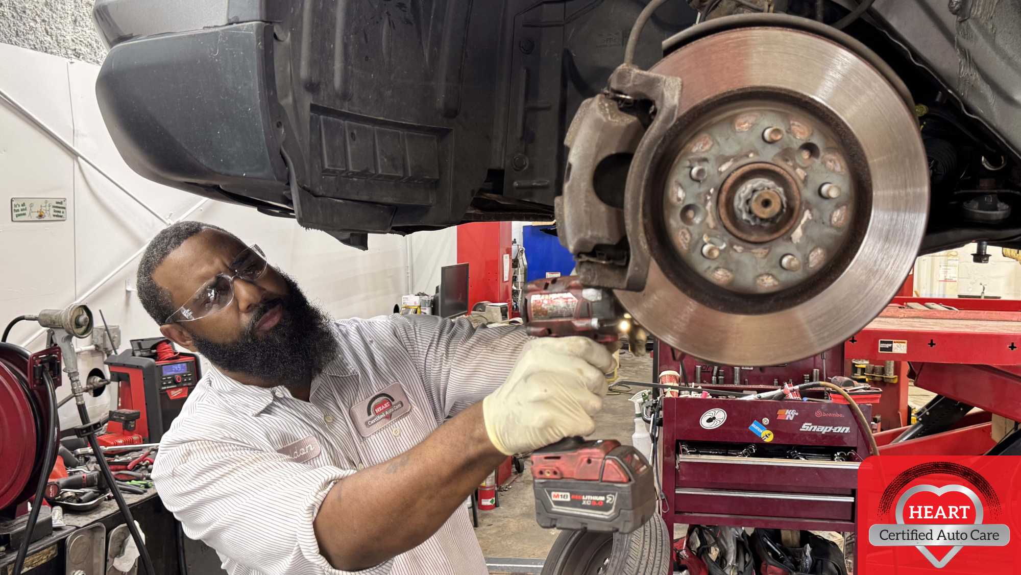 Mechanic inspecting squeaky brakes in Evanston IL