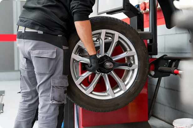 Mechanic inspecting and installing a tire