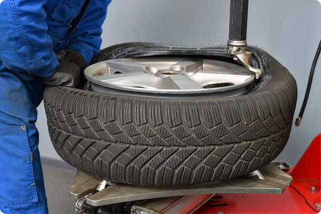 Mechanic inspecting and installing a tire