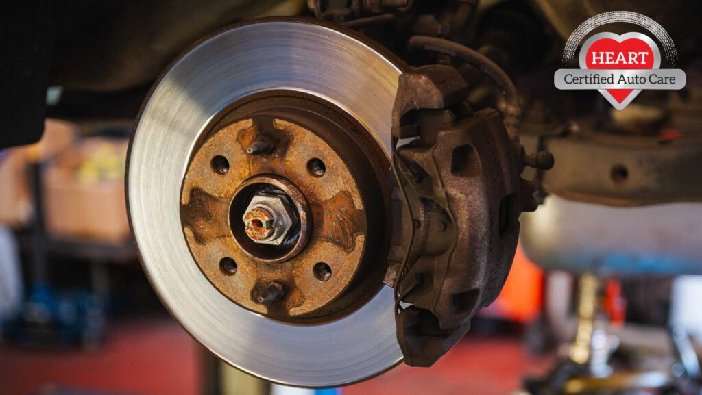 Mechanic inspecting warped brake rotors in Northbrook IL