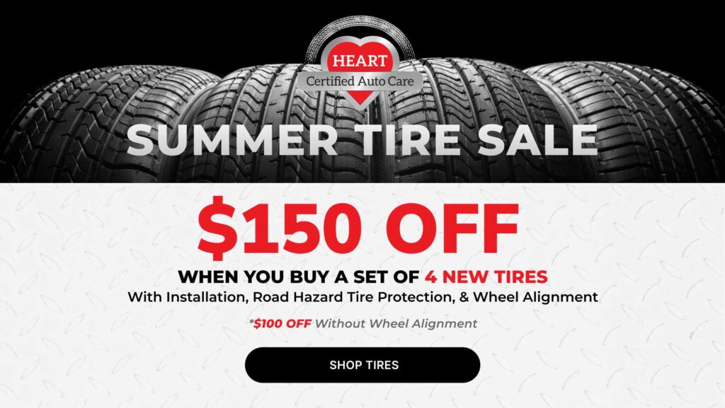 Technician installing new tires during Tire Specials at HEART Certified Auto Care