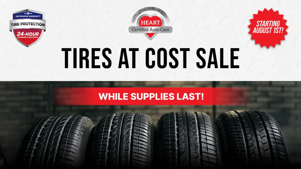 Technician installing new passenger tires during the August Tire Sale at HEART Certified Auto Care